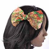 Leopard and floral print hair bow clip accessory on woman