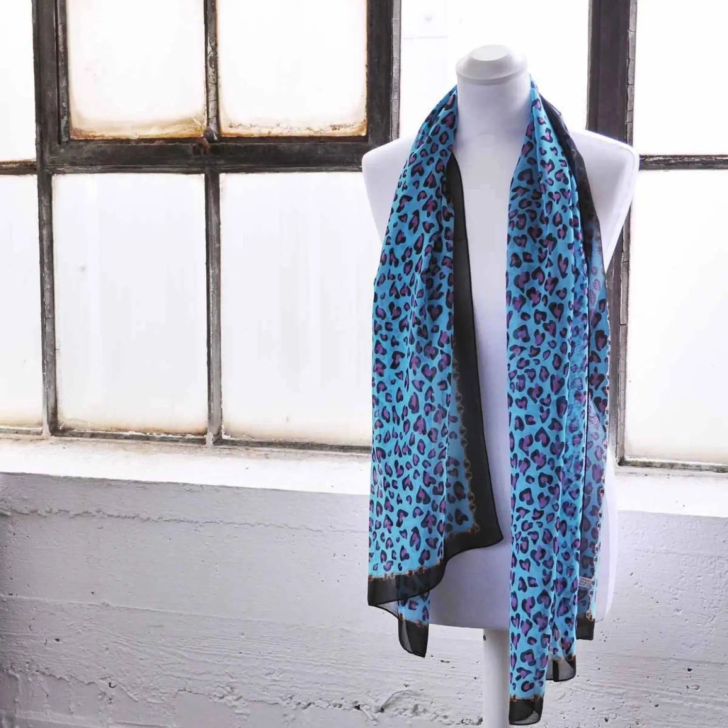 Leopard print chiffon scarf with chain border on mannequin
