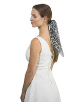 Woman wearing white dress and leopard print scarf in Leopard Print Chiffon Square Neck Scarf.