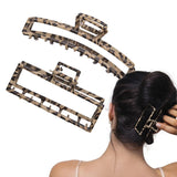 Woman with hair in bun wearing Leopard Print Metal Hair Claw Set - Various Sizes