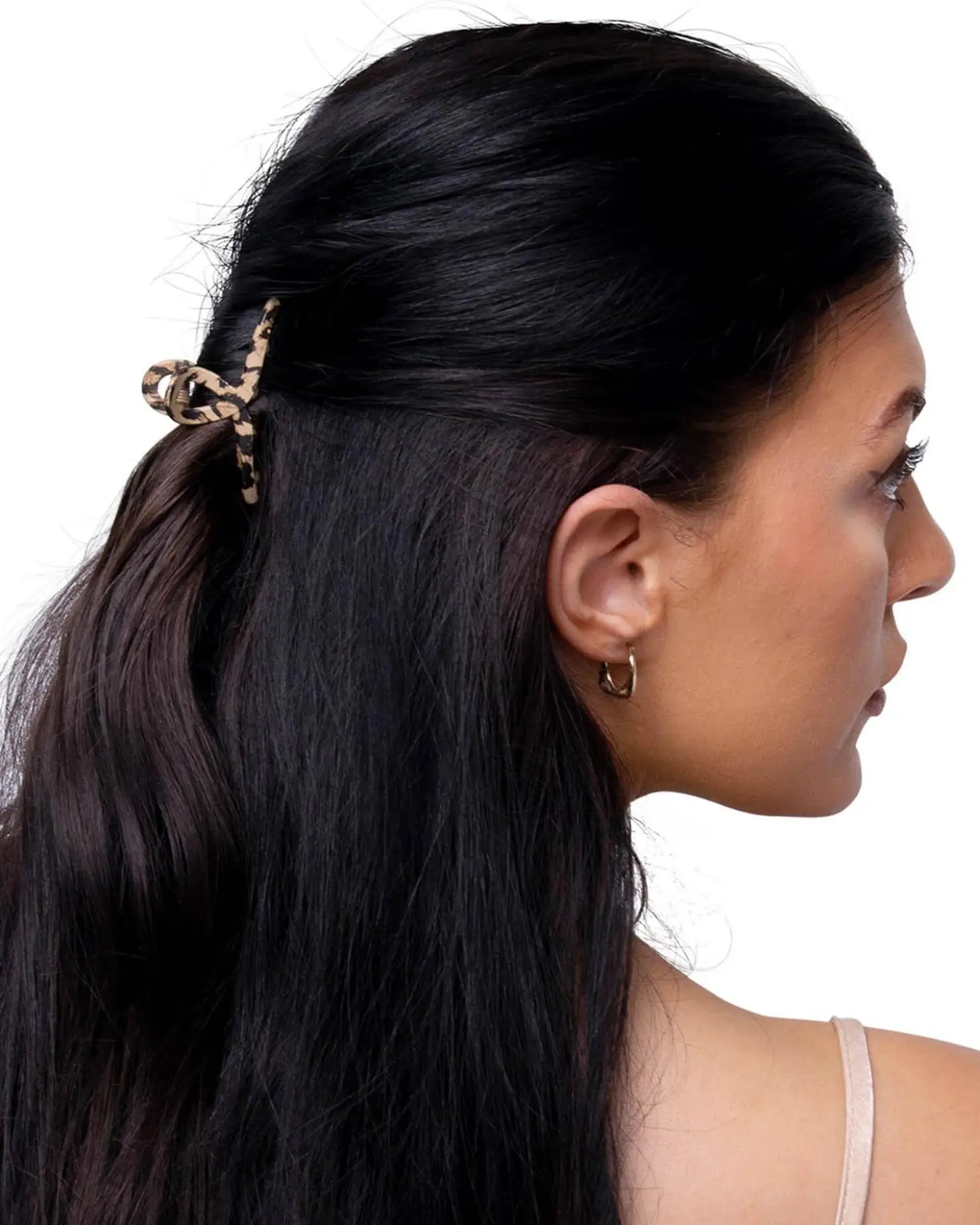 Woman with long black hair wearing gold hair clip from Leopard Print Metal Hair Claw Set