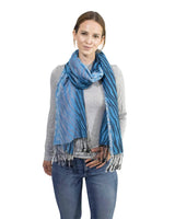 Woman wearing a blue and white zebra print tasselled oversized scarf
