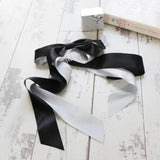 Black and white double satin bow hair comb for women.