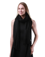 Luxurious Cashmere Feel Oversized Scarf: Woman wearing black scarf.