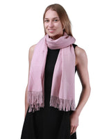 Woman wearing a pink cashmere feel oversized scarf.