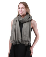 Luxurious cashmere feel oversized scarf worn by a woman
