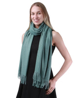 Woman wearing green cashmere feel oversized scarf