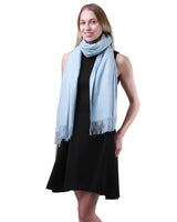 Woman wearing a blue cashmere feel oversized scarf