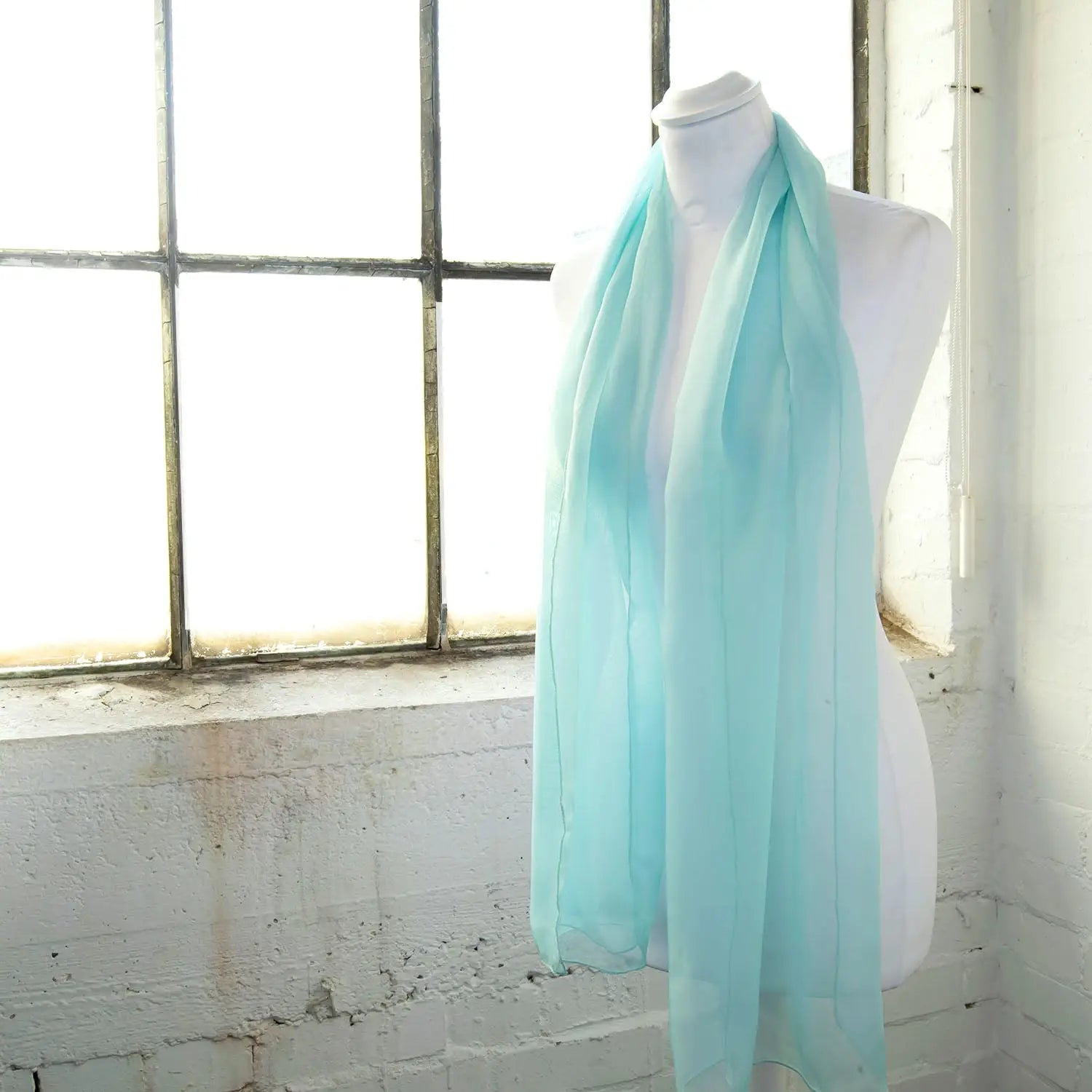 Classic plain chiffon scarf - light blue scarf hanging on a mannequin