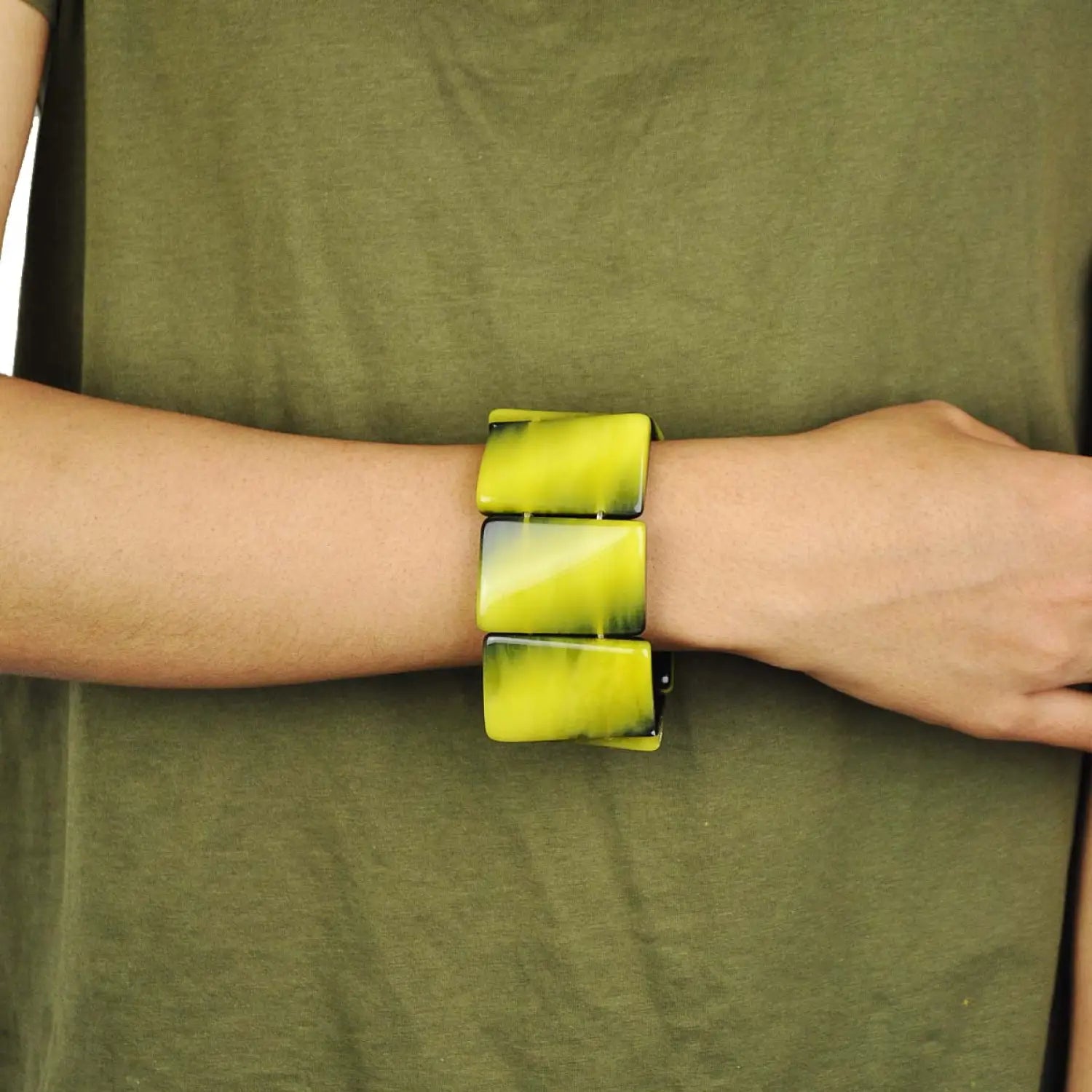 Man wearing green shirt and yellow bracelet showcasing Marbled Chunky Beads Bracelet - Stretchy Handmade Design.