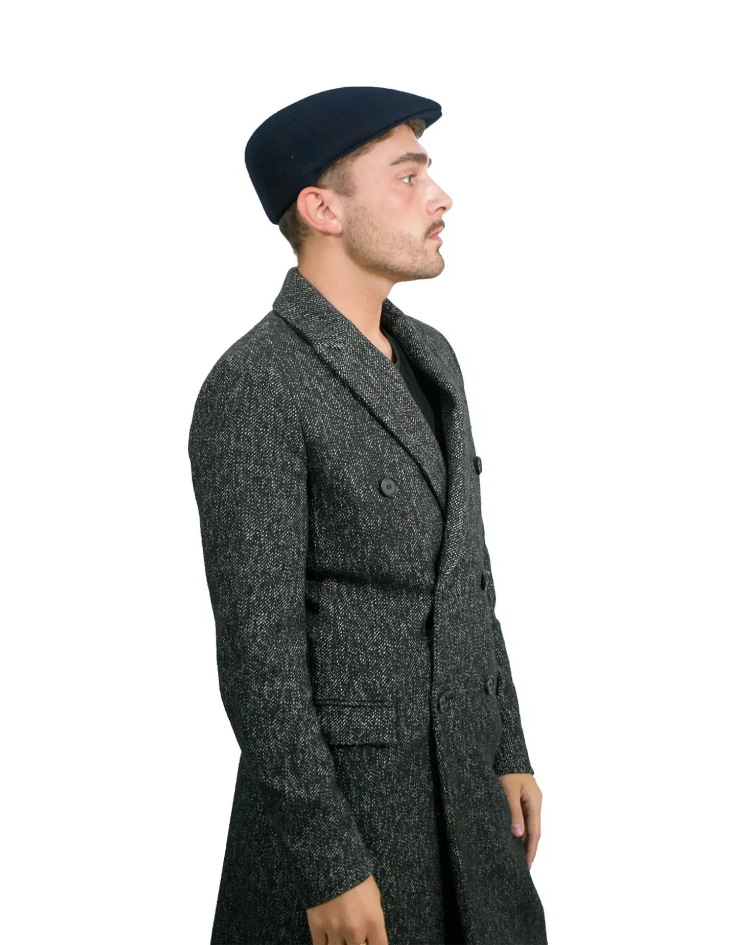 A man wearing a black coat and hat, featuring Men’s Traditional Paperboy Flat Cap.