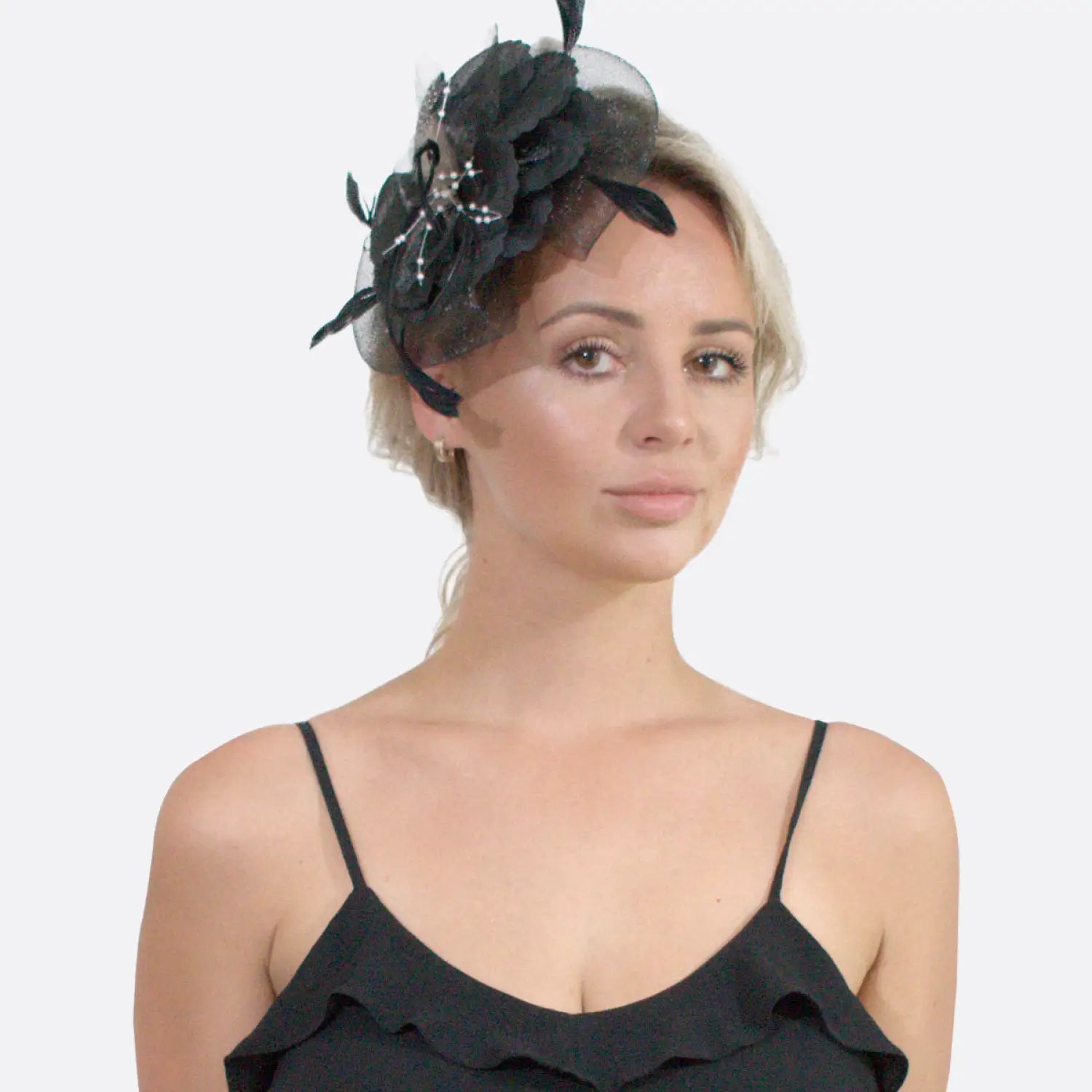 Woman wearing a black hat with mesh flower & feather fascinator.