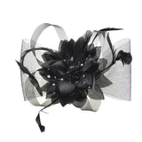 Black mesh flower and feather fascinator hair accessory comb on white background