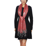 Woman wearing red scarf and metallic aztec print oversized tasselled scarf