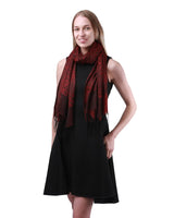 Woman in black dress and red scarf showcasing Metallic Paisley Floral Oversize Scarf.