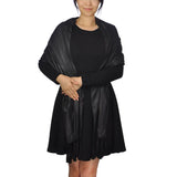 Woman wearing black dress and jacket showcasing Metallic Shimmer Tassel Oversized Scarf.