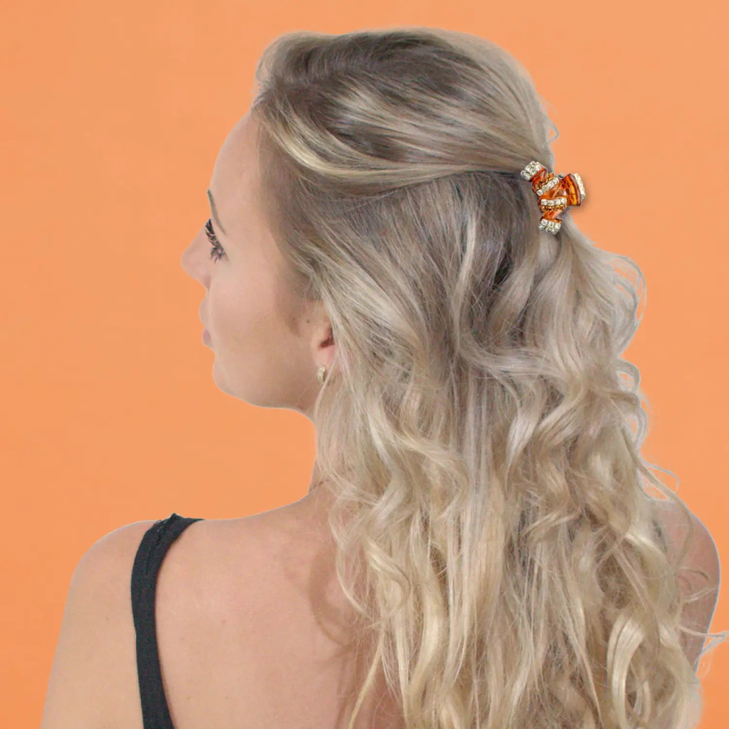 Blonde woman with butterfly clip wearing crystal stripes hair claw