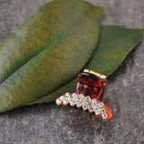 Red and white diamond ring on leaf.