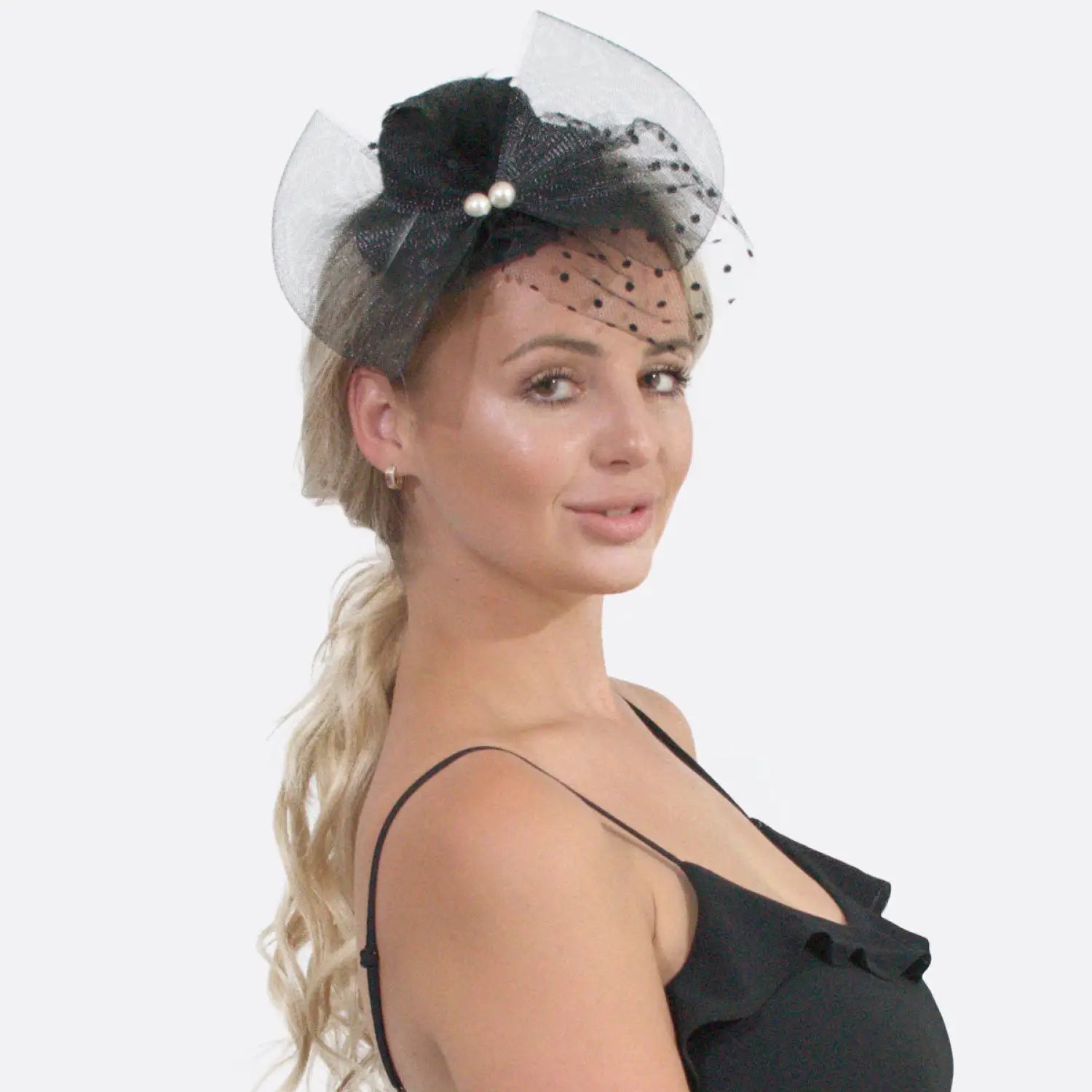 Woman wearing black and white mesh & pearl fascinator hat