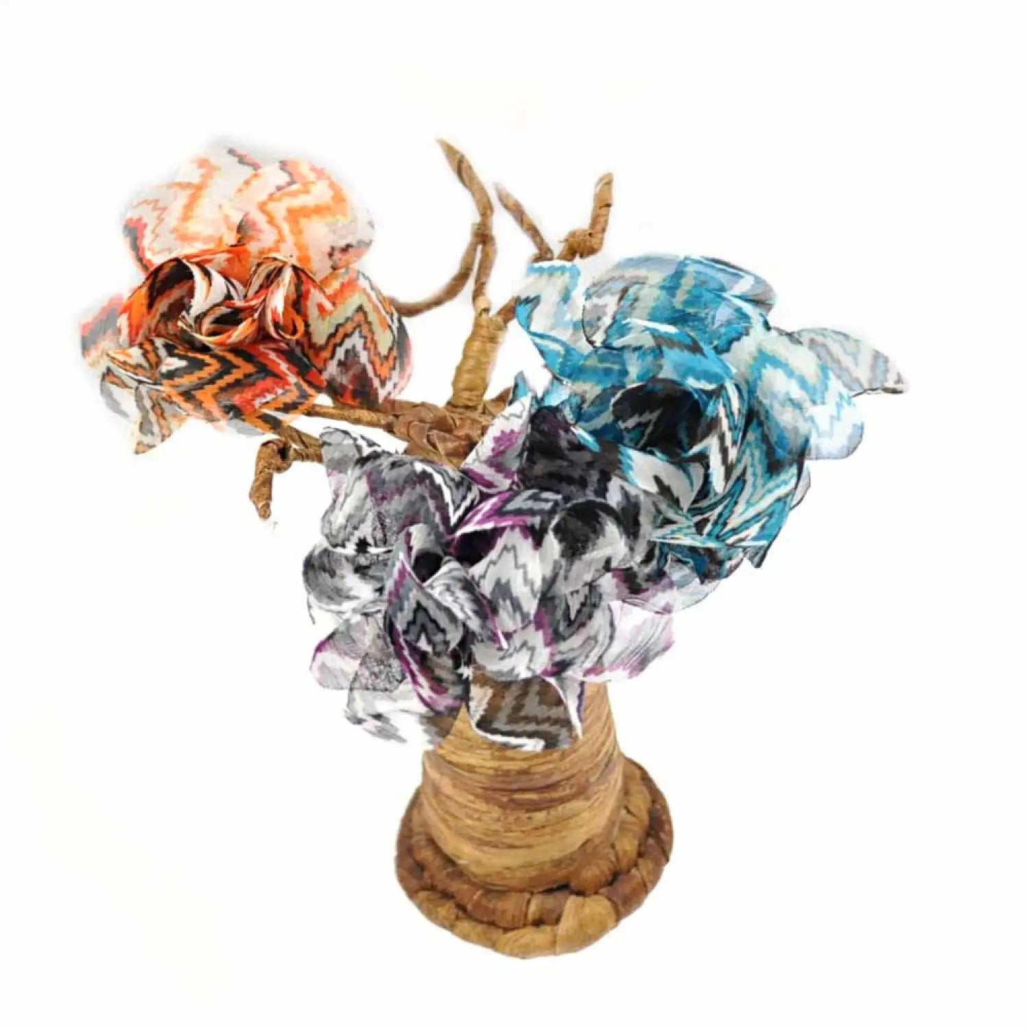 Missoni Print Flower Hair Clip with a vase of flowers in the background