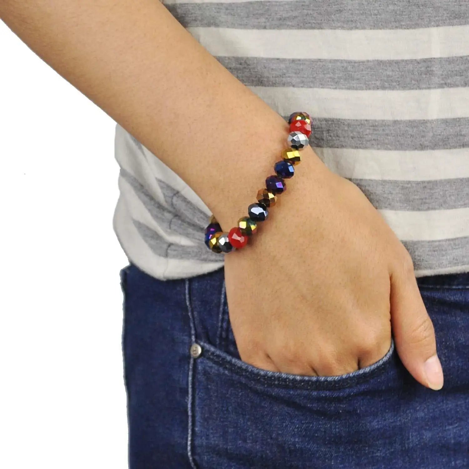 Multi-colour metallic beads stretchy bracelet on a woman’s wrist.