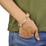 Woman wearing floral bracelet with candy pastel beads