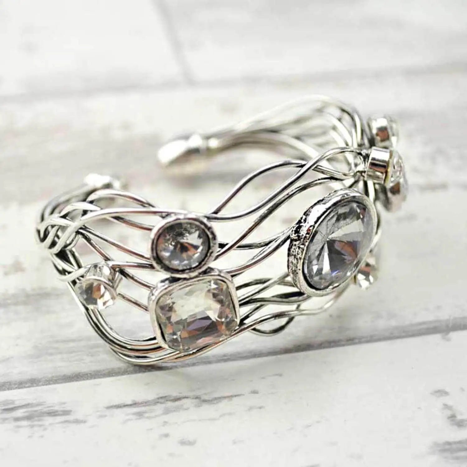 Multi-layered statement bracelet with silver ring and center stone