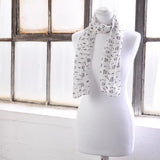 White mannequin with musical notes on Pure Silk Scarf