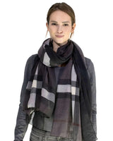 Woman wearing black and grey plaid scarf from Ombre Tartan Oversized Scarf Shawl - Classic Style