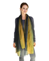 Woman wearing yellow and black ombre tie dye scarf.