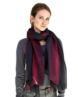 Woman wearing black and red ombre tie dye scarf.