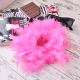 Pink feather hair scrunchie with chocolate bar in background