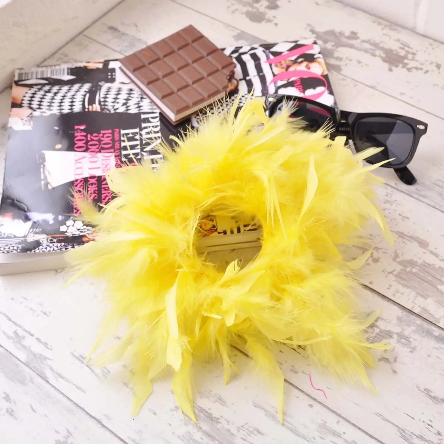 Oversized Feather Hair Scrunchie with Yellow Flower and Chocolate Bar Displayed