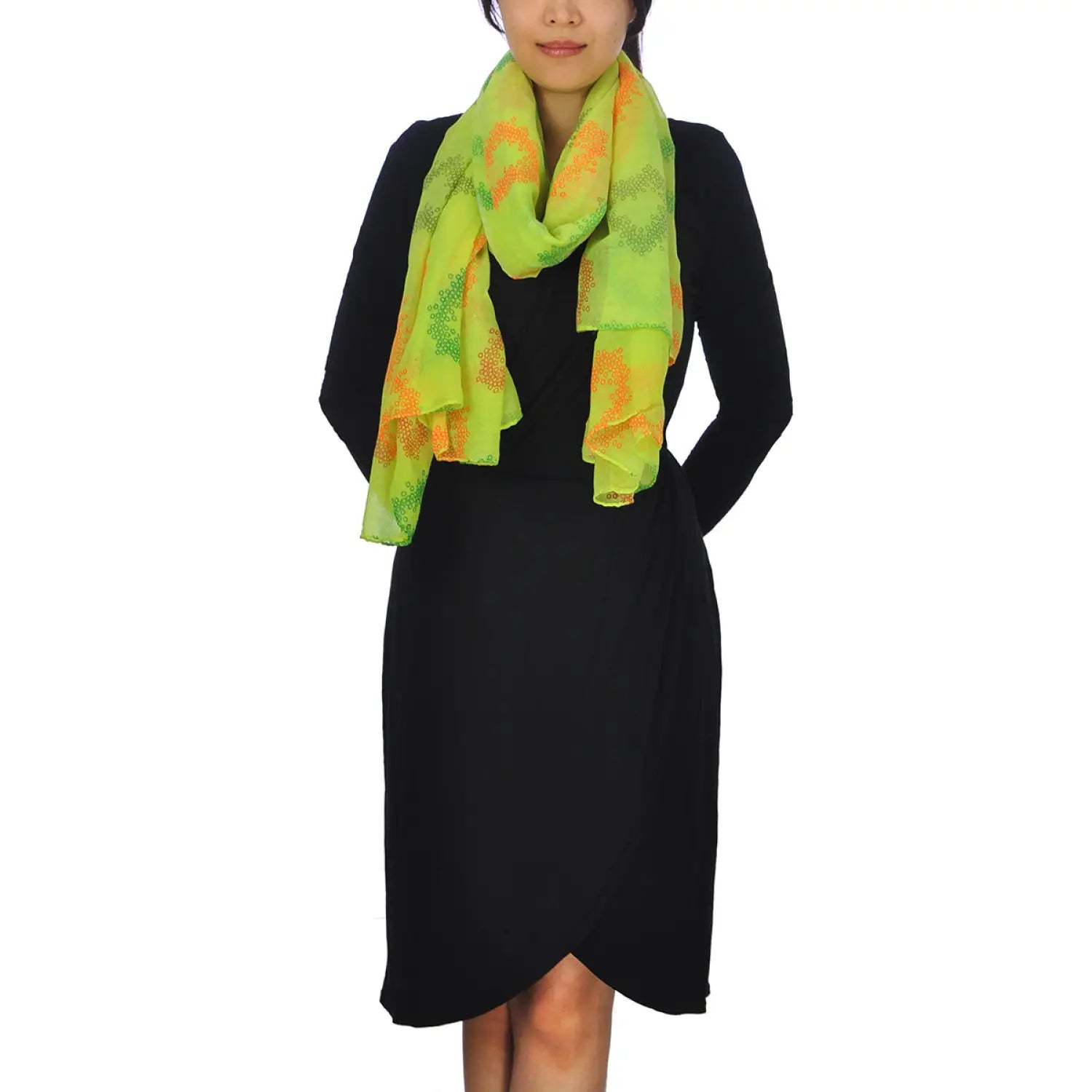 Woman wearing oversized lightweight scarf in neon colours with heart print for year-round style.