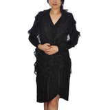 Woman in black dress with black shawl wearing Oversized Netted Lurex Knitted Scarf - Textured & Ruffled with Tassels
