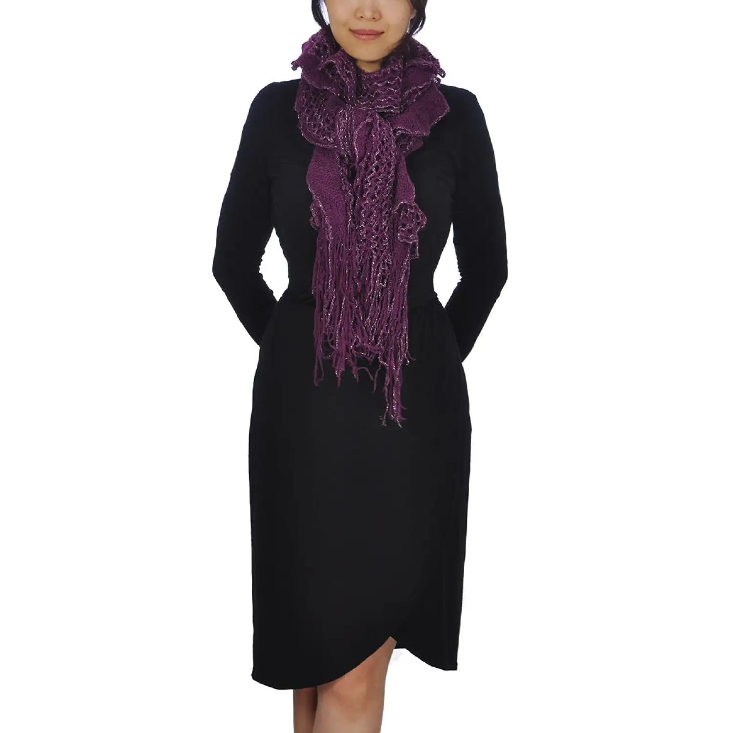 Woman wearing black dress & purple scarf, showcasing oversized netted lurex knitted scarf with tassels.