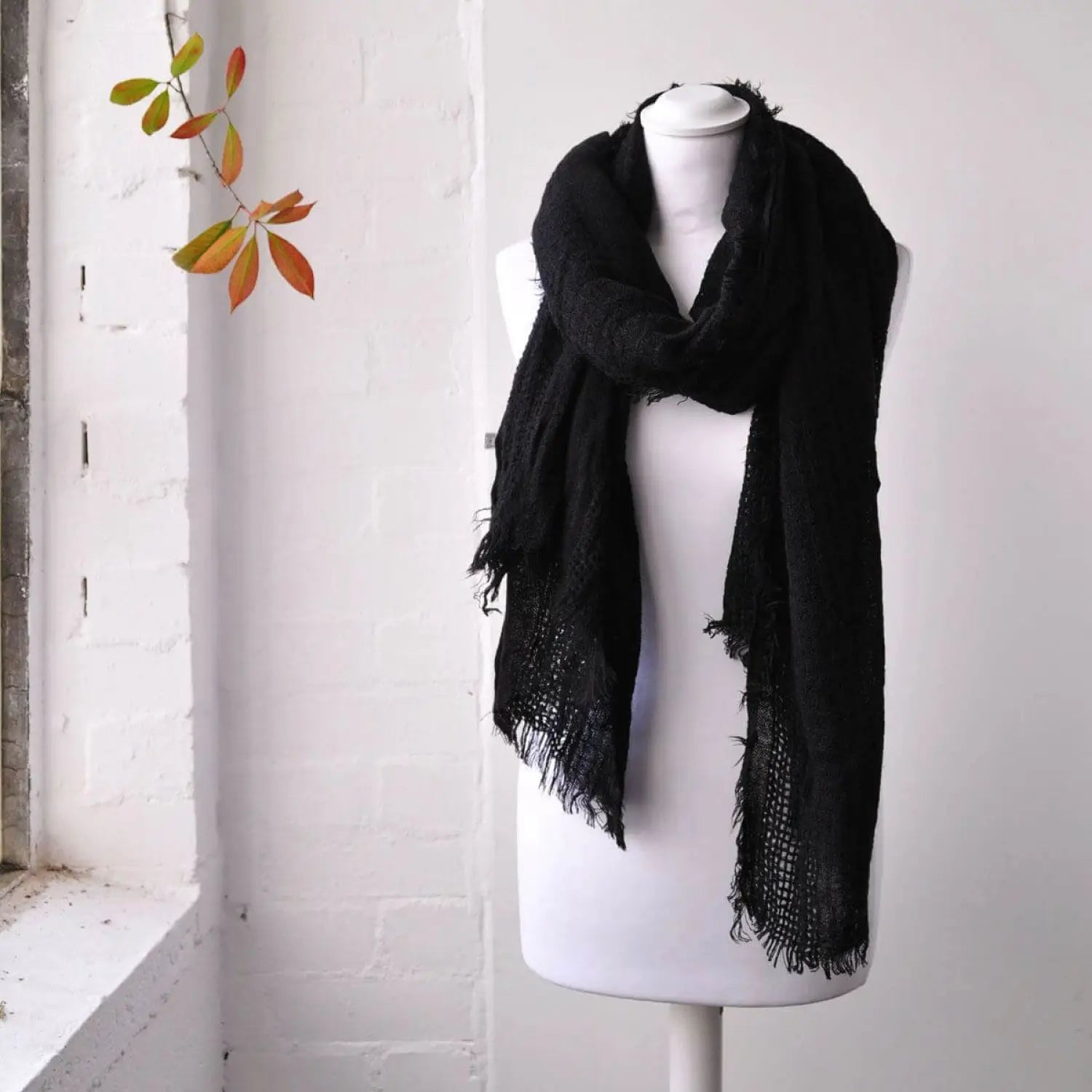 Oversized textured shawl displayed on mannequin with black scarf