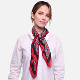 Woman wearing white shirt and red scarf, Paisley Satin Square Scarf on display.