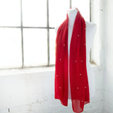 Red pearl chiffon scarf hanging on white mannequin