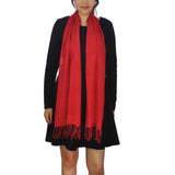 100% cotton textured woven scarf worn by a woman in red