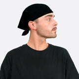 Man wearing a black hat and black shirt featuring Plain Solid Bandana 100% Cotton Square Bandanna.