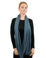 Woman wearing a blue pleated ribbed snood scarf.