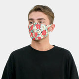 Young man wearing Poinsettia Print Christmas copper-infused face mask.