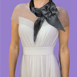 Woman wearing white polka dot sash scarf with matching hair pin from product Polka Dot Satin Sash Scarf & Matching Hair Pin Set