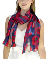 Red and blue poppy floral print scarf worn by woman in Poppy Floral Print Scarf & Gold Plated Ring Set.