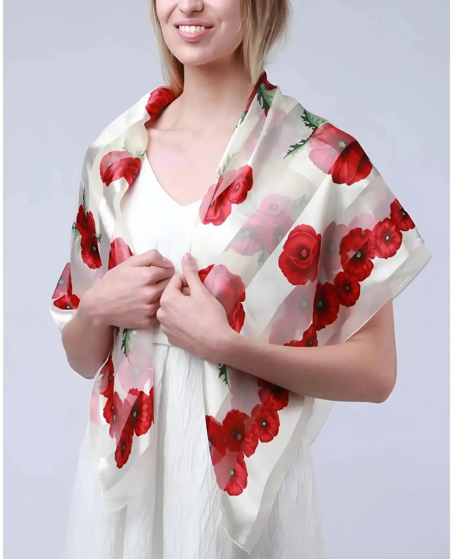 Woman wearing a white dress with red poppy print, showcasing Poppy Square Scarf & Holder Set for Remembrance Day