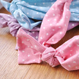 Colorful bows tied on wooden surface, Retro Heart Print Denim Elastic Headband with Bow.