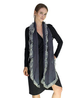Woman wearing black dress and leopard print knit scarf