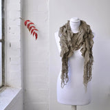 Ruffled knitted scarf on mannequin display