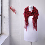 Lightweight knitted ruffled scarf with fringes on mannequin